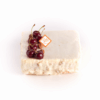 Gâteau Ivoire de La Maison Gélis composé d’une gelée de cerises, d’un crémeux fève de Tonka, d’une ganache montée à la vanille et d’une dacquoise noisettes, décoré de cerises fraîches.